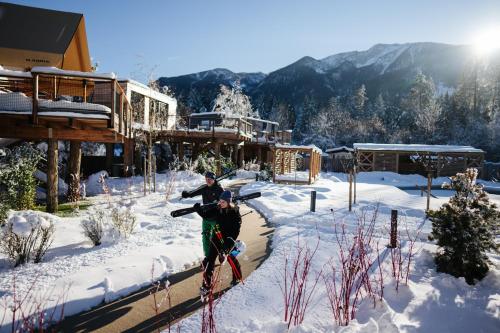 a person riding a bike in the snow at Lakeside Petzen Glamping in Unterlibitsch