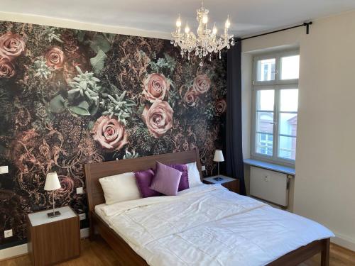 a bedroom with a bed with a floral wall at Schlossblick - a62076 in Heidelberg