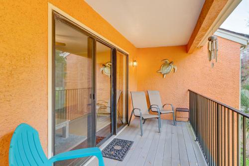 a patio with a blue chair on a deck at Beckenham in Hilton Head Island