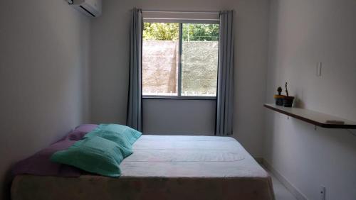 Cama ou camas em um quarto em Apartamento Mel do Cacau à 100mts da praia dos Milionários, Ilhéus
