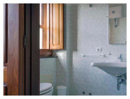 a bathroom with a sink and a toilet at Monastero Santa Chiara CpF in Oristano