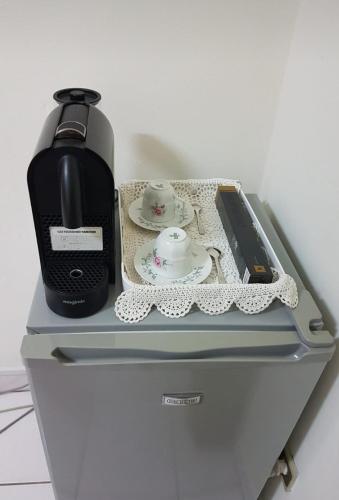 a coffee maker sitting on top of a refrigerator at Résidence Lina in Libreville
