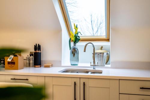 a kitchen counter with a sink and a window at 28 St John's Mews in York