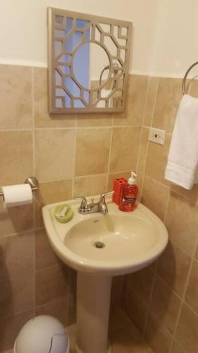 a bathroom with a sink and a mirror at Oceanview 6th Floor Jaco Condo in Jacó