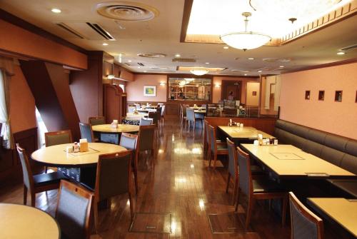 a restaurant dining room with tables and chairs at Hida Takayama Washington Hotel Plaza in Takayama