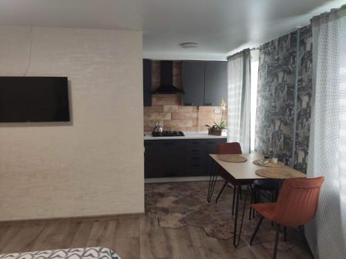 a kitchen and dining room with a table and chairs at Boulevard in Kremenchuk