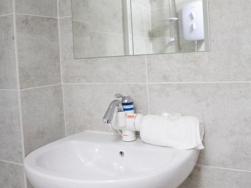 a white sink in a bathroom with a mirror at George's Studio @ Liver House in Rock Ferry