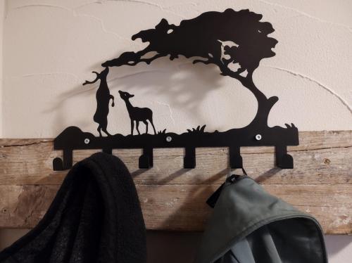 a wooden shelf with a tree and animals on it at Minicamping und B&B Apartment Hintergarten in Niederorschel