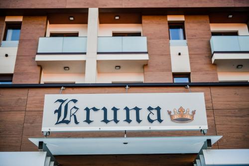 a sign for a hotel in front of a building at Zlatna Kruna in Banja Luka