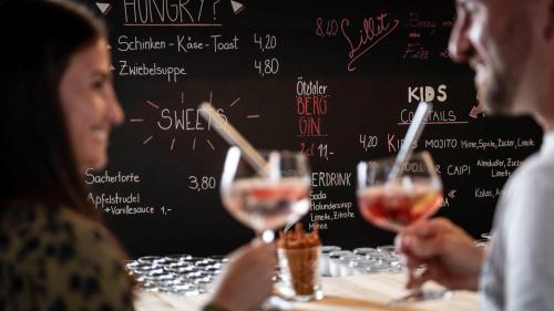 a group of people sitting at a table with wine glasses at die berge lifestyle-hotel Sölden in Sölden