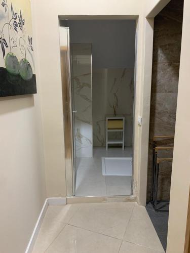 a glass door leading into a room with a chair at Apartamentos La Unión in Arroyo de la Luz