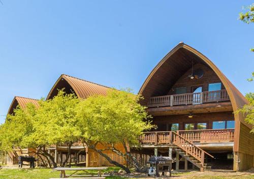 a large wooden house with a gambrel roof at Canyon Lakeview Resort in Canyon Lake