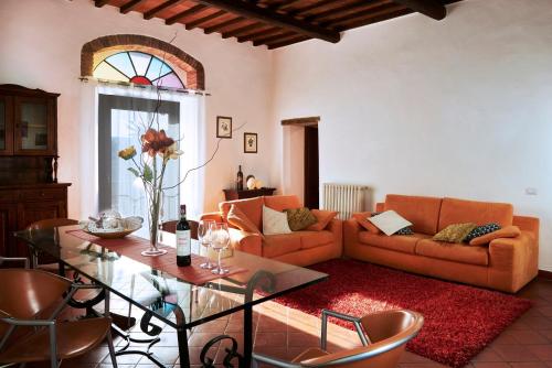 a living room with a couch and a glass table at Casa Lavanda Panzano in Chianti in Greve in Chianti