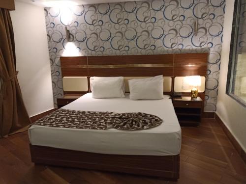 a bedroom with a large bed with a large headboard at Fleet Club Mahrousa in Alexandria