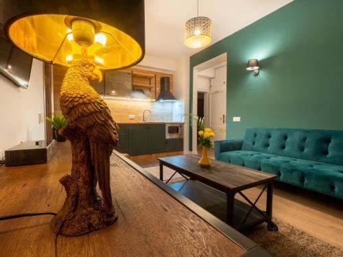 a statue of a bird on a table in a living room at Signature Aparthotel - Boutique in Galaţi