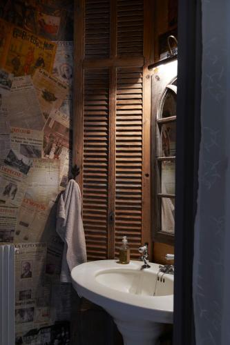 a bathroom with a white sink and a window at Mas de Garrigue in Calvignac