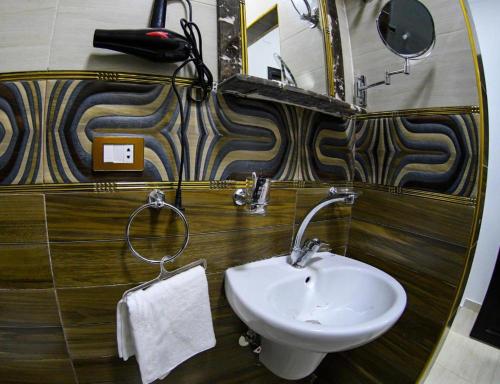 a bathroom with a white sink and a mirror at Cairo City in Cairo