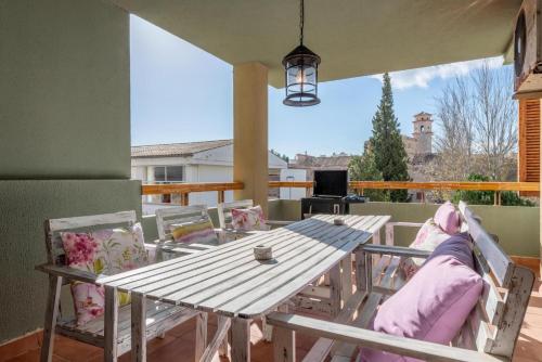 a table and chairs on a patio with a view at BRESSOL DELUXE Apartments in Port de Pollensa