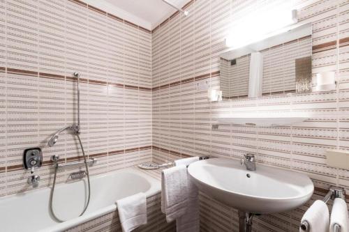 a white bathroom with a tub and a sink at Landhotel zum kühlengrund & soultans paradise in Brensbach