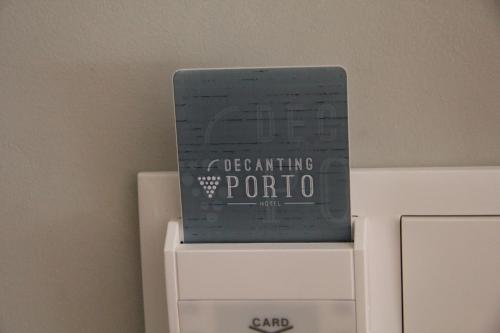 a book is sitting on top of a computer at Decanting Porto House in Porto