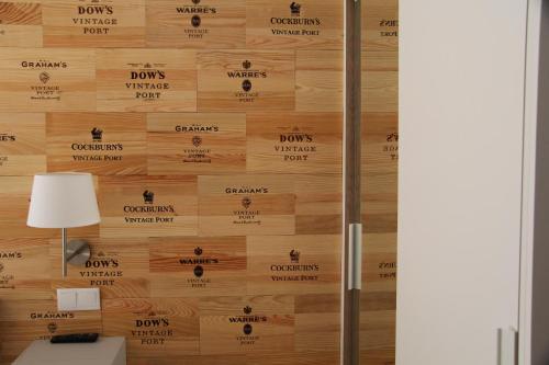 a wooden wall with a door with the dons logo on it at Decanting Porto House in Porto