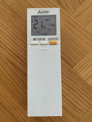 a digital clock sitting on top of a wooden table at Villa Korppi in Jorvas