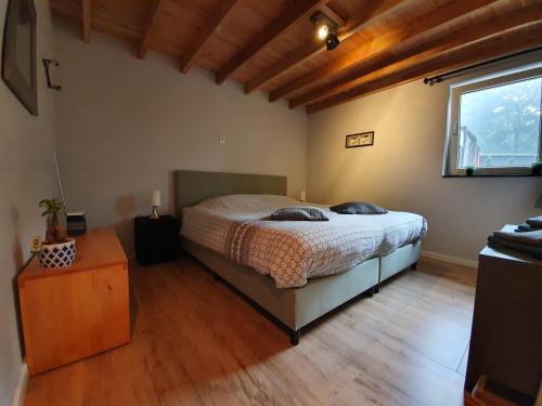 a bedroom with a bed and a wooden floor at Stay America in America