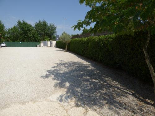a shadow of a hedge on a driveway at Hôtel Villa Sophia - ADULTS ONLY JULY AND AUGUST in Mougins