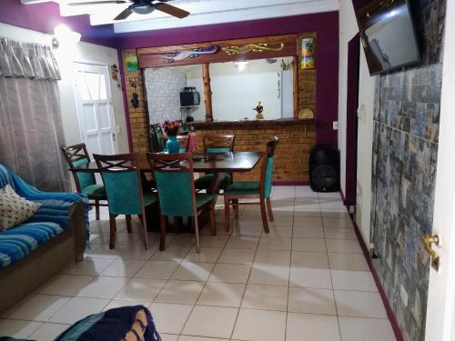 a dining room with a table and chairs at Tu hogar en las cataratas in Puerto Iguazú
