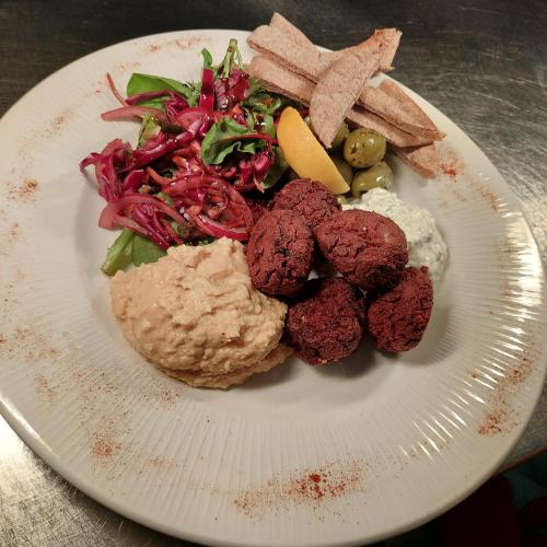 a plate of food with meat and a salad at Trawden Arms Community Owned Pub in Winewall