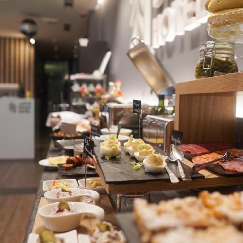 a buffet line with plates of food on display at Hotel JeštěBrno in Brno