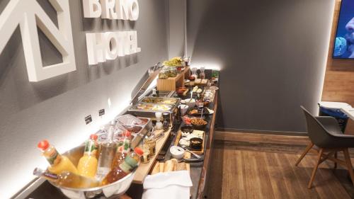 a buffet line with food and drinks on it at Hotel JeštěBrno in Brno