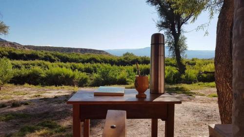 a table with a book and a vase on it at Matices de Molinos Hostal in Molinos