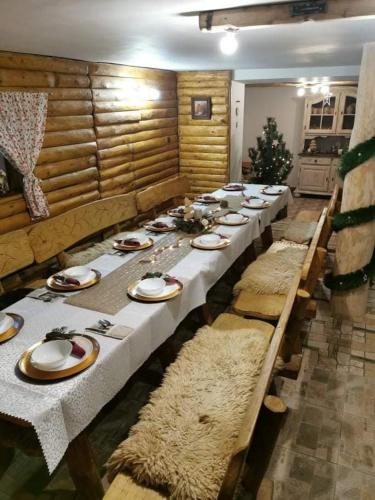 a long long table with plates and dishes on it at U Eli I Tomka in Krzyżowa