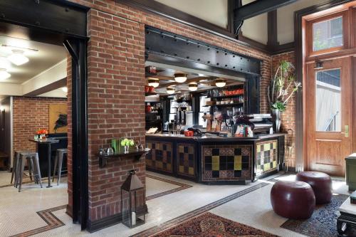 a room with a brick wall and a bar at The High Line Hotel in New York