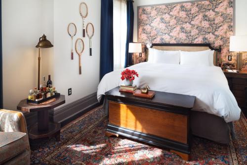 a bedroom with a large bed with a floral headboard at The High Line Hotel in New York