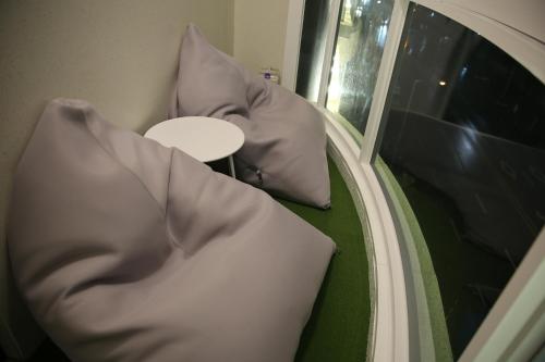 two pillows sitting on the floor in front of a mirror at EKklim Classic Hotel in Pyeongtaek