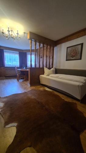 a large bedroom with a bed and a desk at Hotel Tyrolis in Zirl