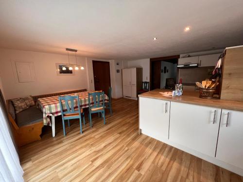 a kitchen and dining room with a table and chairs at Ferienhaus Gertrud in Nesselwängle