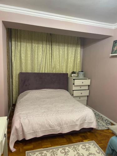 a bedroom with a bed and a dresser and a window at 2-х комнатная квартира in Pizunda