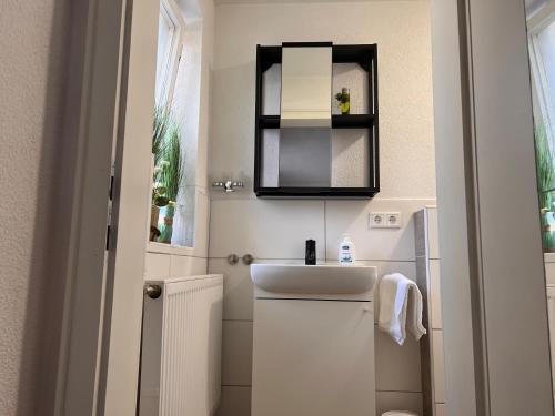 a small bathroom with a sink and a mirror at Ferienhaus Gertrud in Nesselwängle
