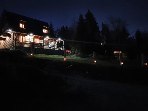a house lit up at night with lights at Domek w Górach- Bacówka u Dudka in Nowy Targ
