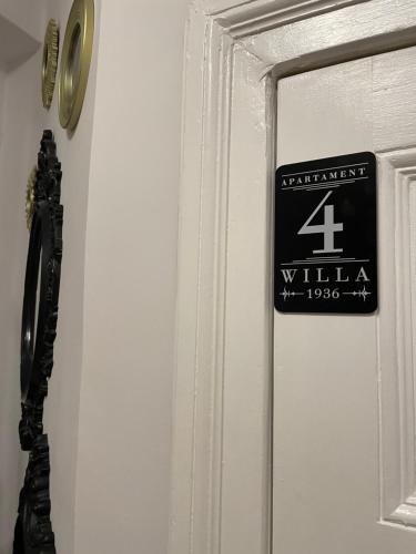a door with a willias sign on it at Willa 1936 , Parking in Toruń