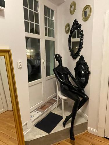 a statue of a woman sitting in a chair at Willa 1936 , Parking in Toruń