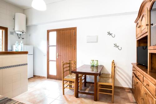 a kitchen with a table and chairs in a room at Apartamentos Molina 9-10-11 in Es Calo