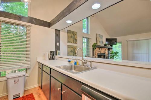 a kitchen with a sink and a large mirror at Osage Beach Getaway - 1 Mi to Margaritaville Fun! in Osage Beach