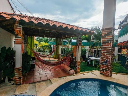 a patio with a hammock and a swimming pool at KasaGrande in Santa Fe de Antioquia