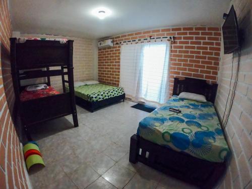a room with a bed and a bunk bed at KasaGrande in Santa Fe de Antioquia