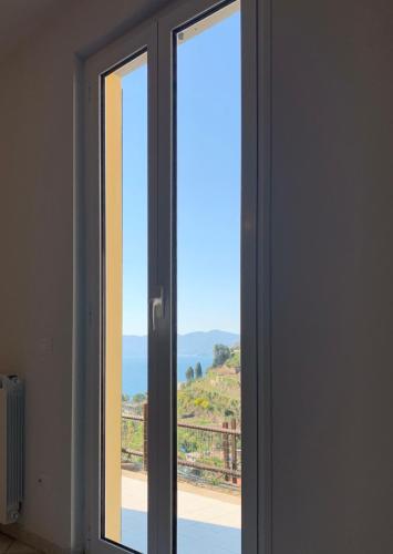 a sliding glass door with a view of a mountain at Orizzonti Apartments in Manarola