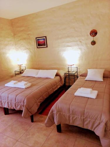 a room with two beds in a room at Hosteria Felipa Pastor - Ex Munay Humahuaca in Humahuaca